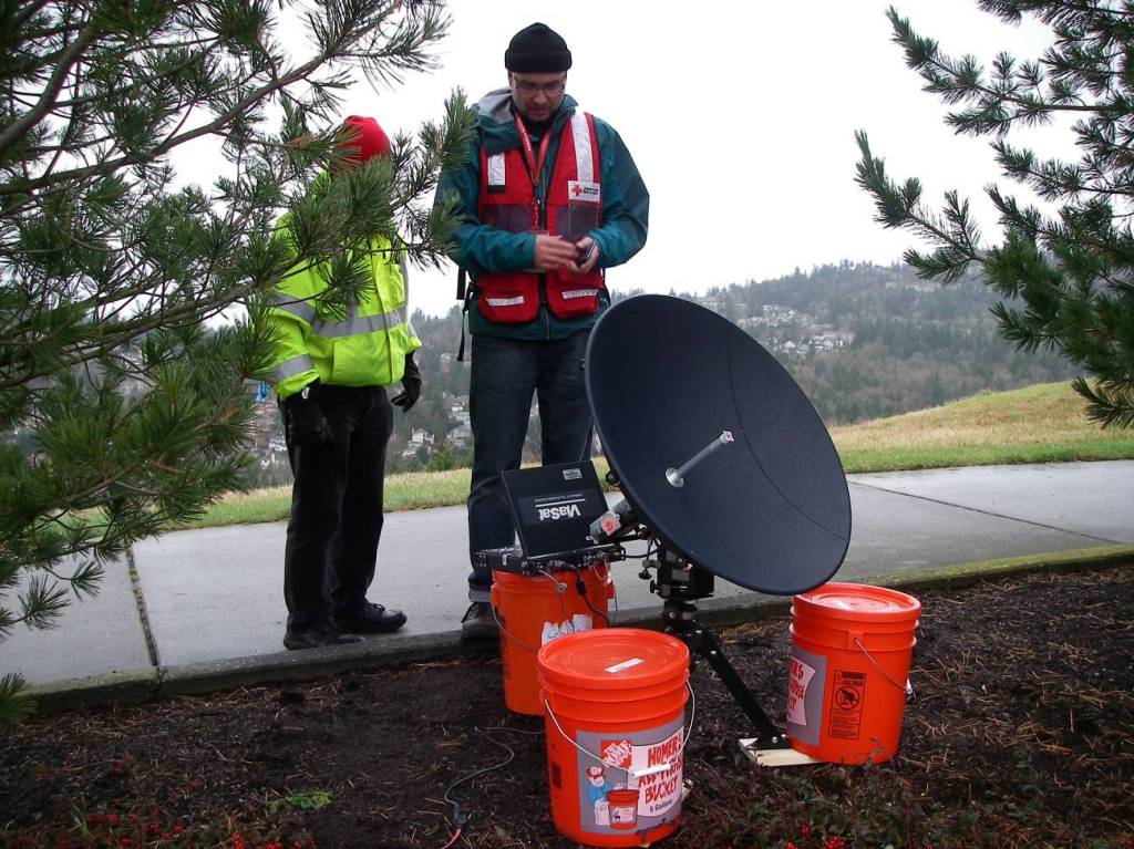 ViaSat dish setup with ballast buckets, with Dave Hersey, KE7PBA and John Carscadden, W7AFX.