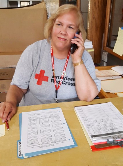 volunteer-kathy-brasch-welcomes-evacuees-to-the-shelter.jpg